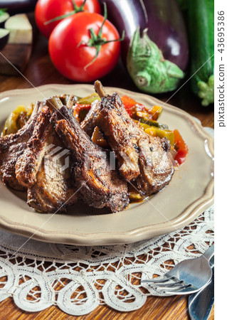 Roasted lamb chops served with ratatouille Roasted lamb chops served with ratatouille 43695386
