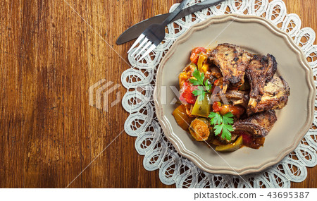 Roasted lamb chops served with ratatouille Roasted lamb chops served with ratatouille 43695387