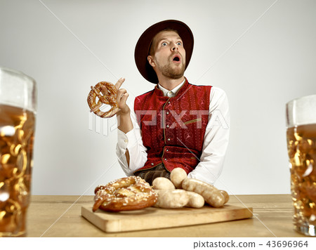 Germany, Bavaria, Upper Bavaria, man with beer dressed in traditional Austrian or Bavarian costume 43696964