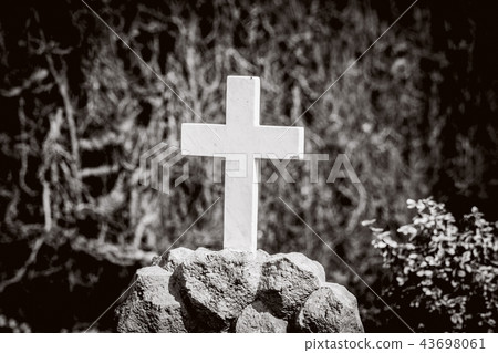 White cross on a tomb in sepia colors White cross on a tomb in sepia colors 43698061
