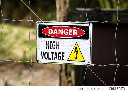 High voltage sign on a fence 43698073