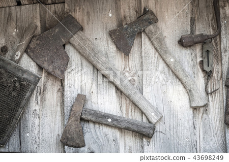 Old axes hanging on a wall Old axes hanging on a wall 43698249