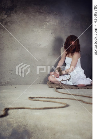 Young girl tied up on the floor