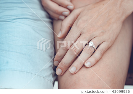 Close up of couple hands with silver ring  43699926