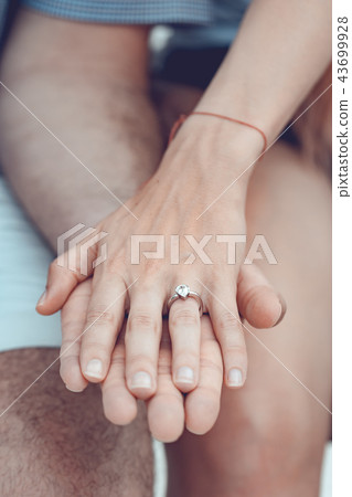 Close up of couple hands with silver ring  43699928