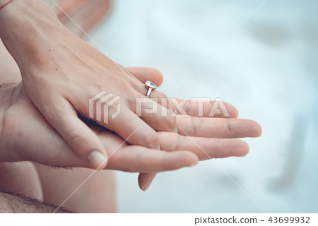 Close up of couple hands with silver ring  43699932