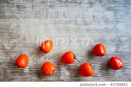 Top view of ripe persimmons on wooden table Top view of ripe persimmons on wooden table 43700681