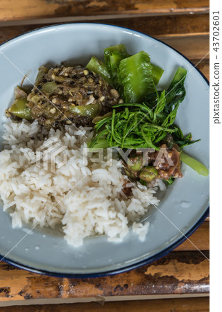 Rice with chili sauce and vegetable on wood table Rice with chili sauce and vegetable on wood table 43702601