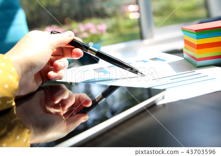 businesswoman working with graphs in the office businesswoman working with graphs in the office 43703596