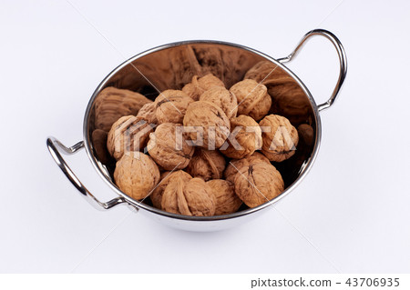 Walnut in a stainless steel bowl 43706935