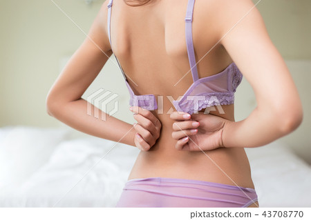 Young beautiful  model taking off her bra 43708770