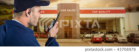 Composite image of close up of security officer talking on walkie talkie 43708979