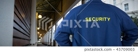 Composite image of rear view of security officer in uniform 43709003