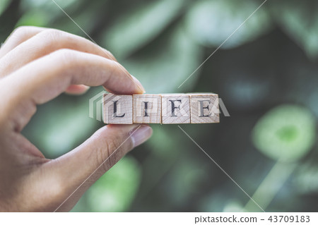 Person's hand with LIFE 43709183