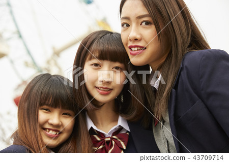 High school girl playing in amusement park High school girl playing in amusement park 43709714