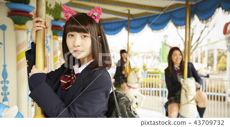 High school girl playing in amusement park High school girl playing in amusement park 43709732