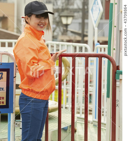 Girl doing part-time job in amusement park 43709864