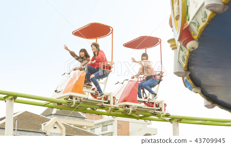 A girl playing at an amusement park A girl playing at an amusement park 43709945