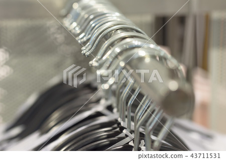 hangers with clothes in the store 43711531