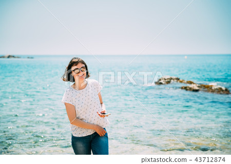 Young Caucasian Girl Woman Dressed In White Shirt And Blue Jeans 43712874