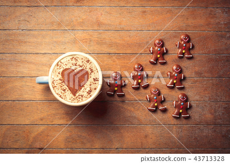 gingerbread man and cup of cappuccino gingerbread man and cup of cappuccino 43713328