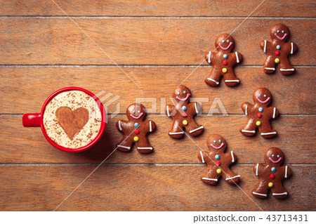 gingerbread man and cup of cappuccino gingerbread man and cup of cappuccino 43713431