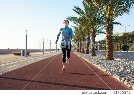 Girl jogging on the running track, active lifestyle 43715841