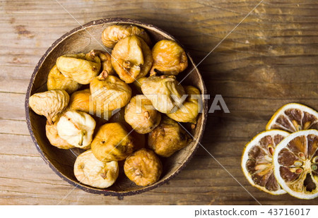 Dry figs in a rustic bowl tabletop shot 43716017