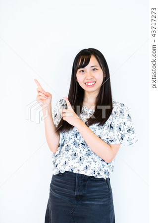 Girl standing in front of white background 43717273