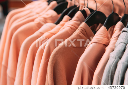 Many One-colour Hooded Sweatshirt On Hanger In Store Of Shopping Many One-colour Hooded Sweatshirt On Hanger In Store Of Shopping 43720970