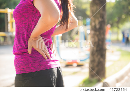 Young asian woman feel pain on her back and hip Young asian woman feel pain on her back and hip 43722564