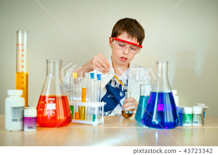 Cute boy is making science experiments in a laboratory 43723342