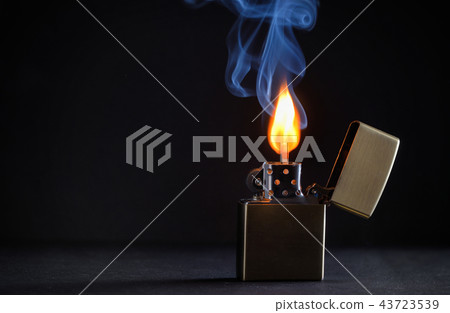 Golden metal lighter and smoke 43723539