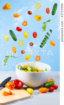 Levitating mixed fresh vegetables blue background 43723990