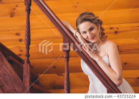 a woman leaned against the railing of the stairs 43725224