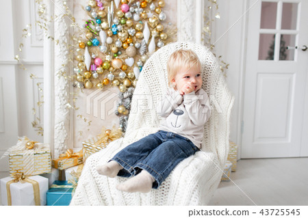Portrait little boy. Happy new year. decorated Christmas tree. Christmas morning in bright living Portrait little boy. Happy new year. decorated Christmas tree. Christmas morning in bright living 43725545