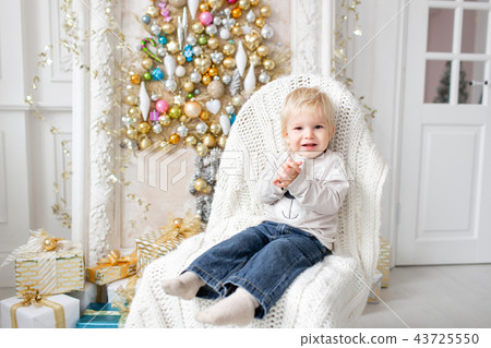 Portrait little boy. Happy new year. decorated Christmas tree. Christmas morning in bright living 43725550