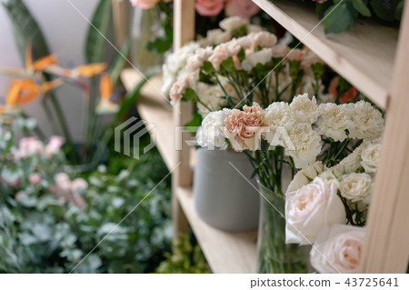 Flower shop concept. Different varieties fresh spring flowers in refrigerator room for flowers Flower shop concept. Different varieties fresh spring flowers in refrigerator room for flowers 43725641