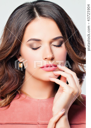 Closeup portrait of beautiful woman with wavy hair Closeup portrait of beautiful woman with wavy hair 43725904