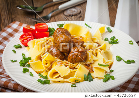 Tagliatelle, meatballs in dark sauce and tomato. 43726557