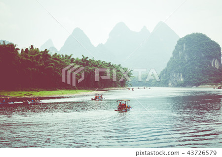 Scenic view of small tourist bamboo rafts sailing 43726579