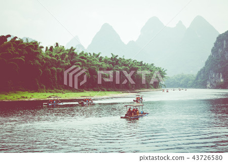 Scenic view of small tourist bamboo rafts sailing 43726580