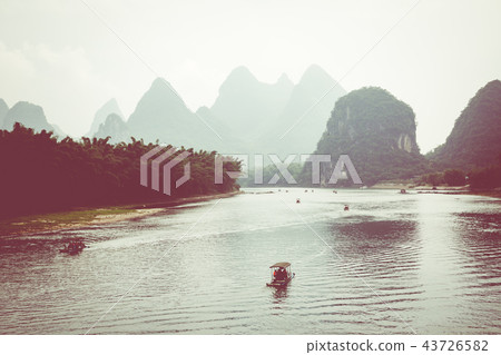 Scenic view of small tourist bamboo rafts sailing 43726582