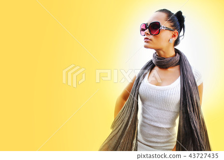 woman with brown scarf on yellow background 43727435