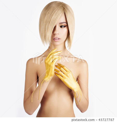 Elegant nude asian woman with gold flowing down her hands 43727787