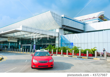 Taxi cab by airport terminal 43727987