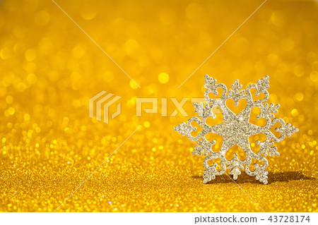Shining snowflake on a golden radiant background. Glitter shine with 3d shape Shining snowflake on a golden radiant background. Glitter shine with 3d shape 43728174