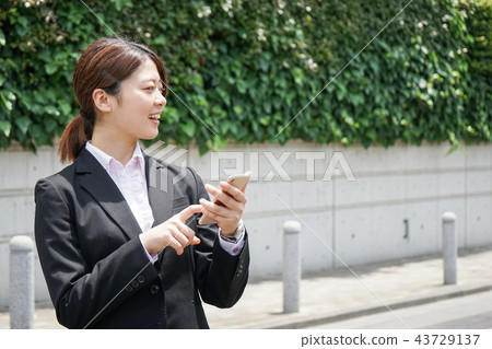 Young Business Woman Finding a Place on a Smartphone Young Business Woman Finding a Place on a Smartphone 43729137