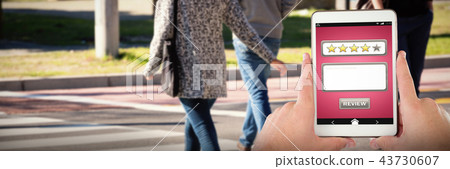 Composite image of cropped hands on businessman with digital tablet 43730607