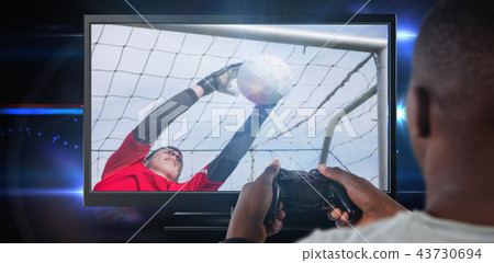 Composite image of man playing video game against white background Composite image of man playing video game against white background 43730694